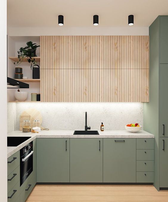 69 a chic contemporary kitchen with light stained and green cabinets, a white marble backsplash and countertops plus black fixtures