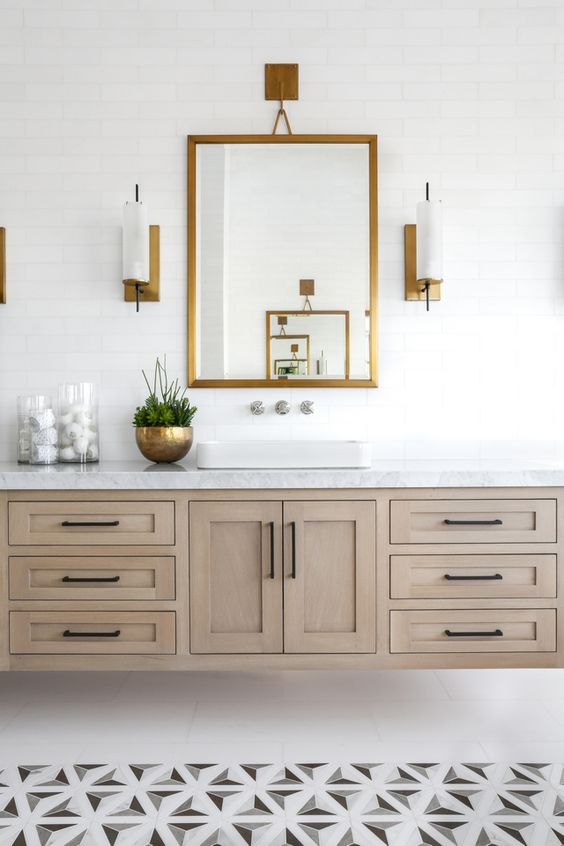 70 a modern farmhouse bathroom with geometric tiles on the floor, a large wooden floating vanity and a mirror