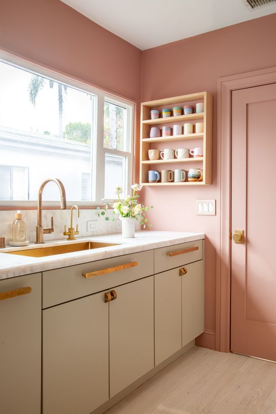 75 a beautiful Scandinavian kitchen with pink walls and grey cabinets, brass fixtures and a brass sink
