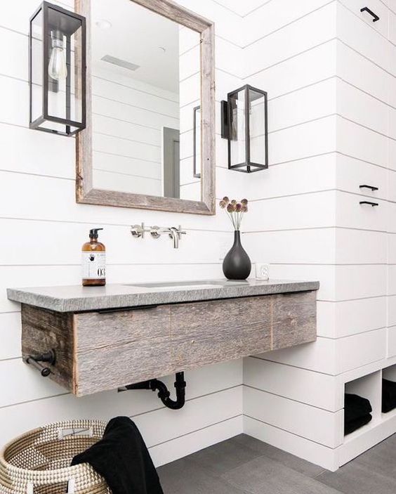 77 a rustic bathroom in neutral, with a floating rough wood vanity and a grey stone countertop is very cool