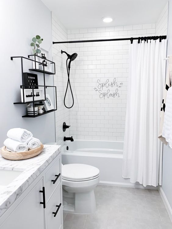 Black fixtures and shelves make this neutral bathroom eye catchy and bold