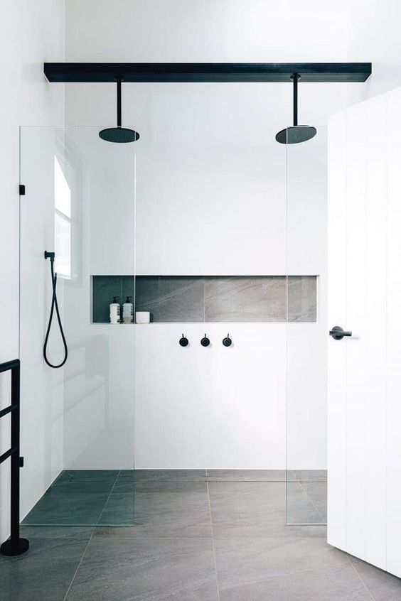 a minimalist white and grey bathroom accented with black fixtures looks more interesting and chic