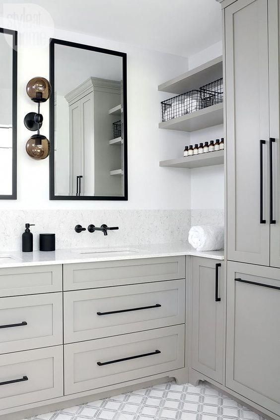 82 a chic grey bathroom with a patterned tile floor, black fixtures and mirrors in black frames
