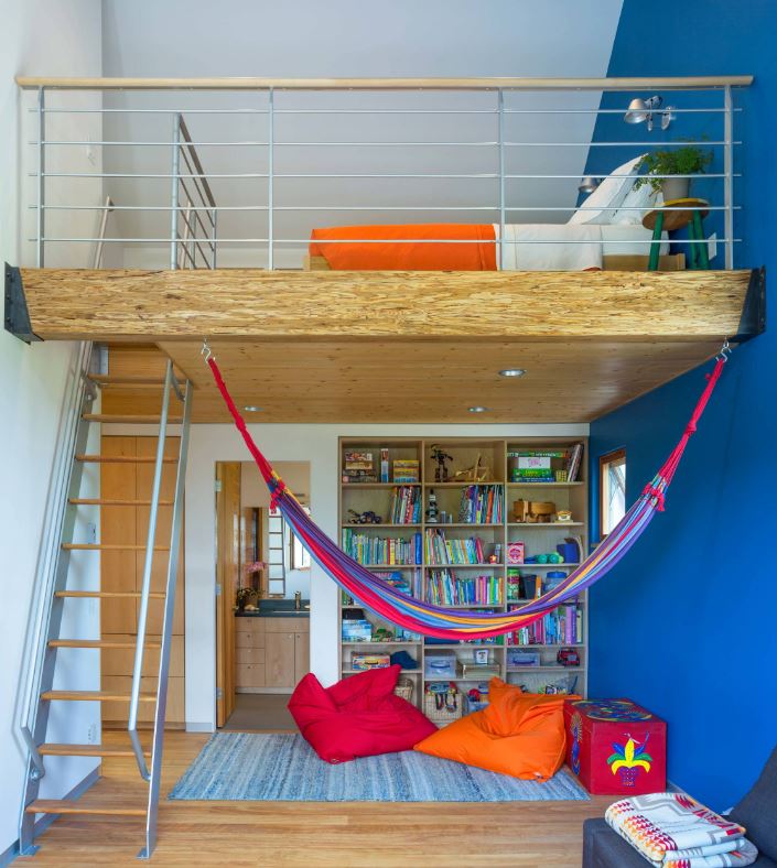 a colorful kids’ space with a lower level for reading and just relaxing and the upper level as a bedroom