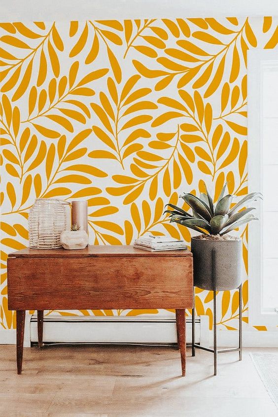Yellow botanical print wallpaper, a mid century modern console, a potted plant to spruce up a small awkward nook