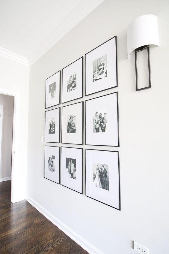 06 a chic and elegant grid gallery wall with black and white family pics and thin black frames is an adorable solution