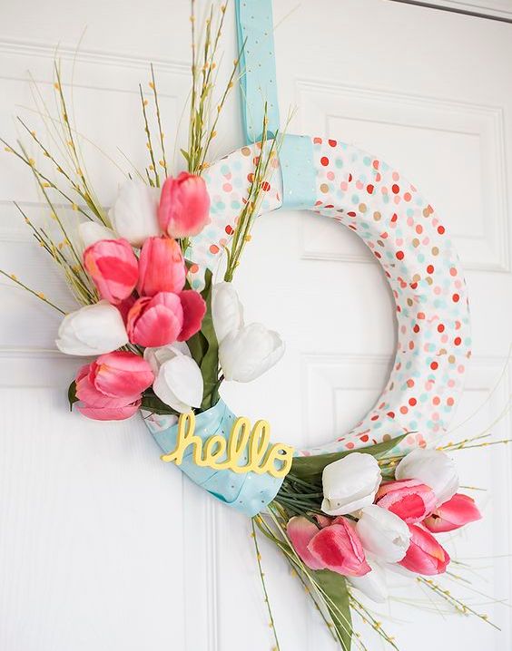 a cute and simple spring polka dot wreath with pink and white faux tulips and greenery is very cute