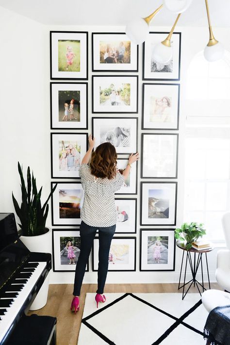 11 a creative grid gallery wall with matching black frames and colored family pics is a cool idea for a modern space