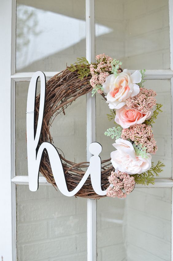 15 a lovely spring wreath of vine, with a calligraphy piece, pink and blush blooms and some greenery is chic
