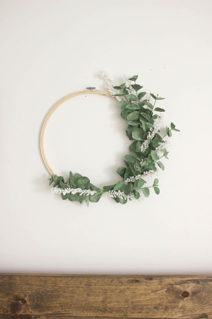 17 a minimalist spring wreath of a hoop, faux greenery and white branches is a pretty and very fresh decor idea