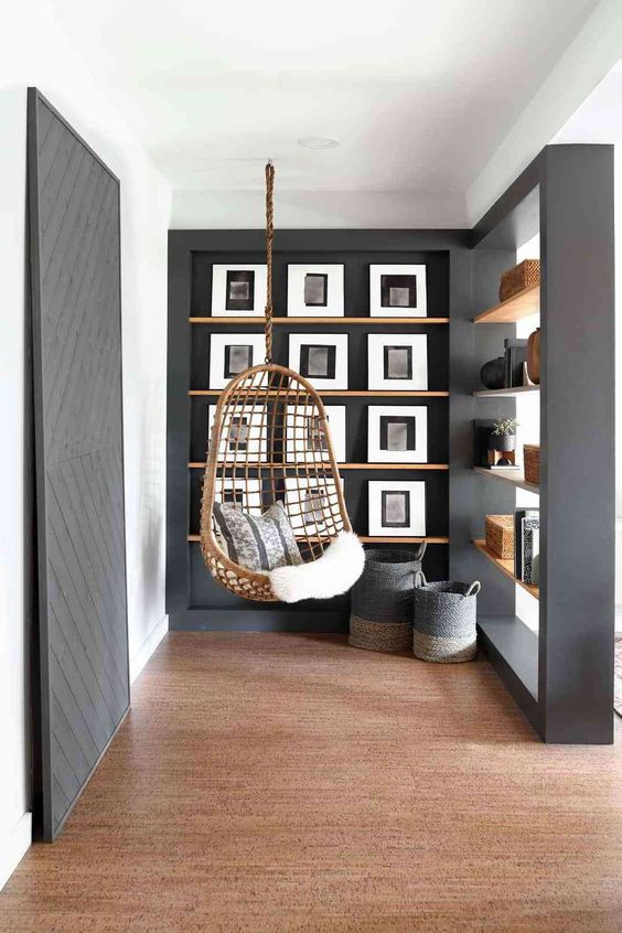 a modern black and white gallery wall on stained ledges looks refined and chic and is easy to compose thanks to ledges
