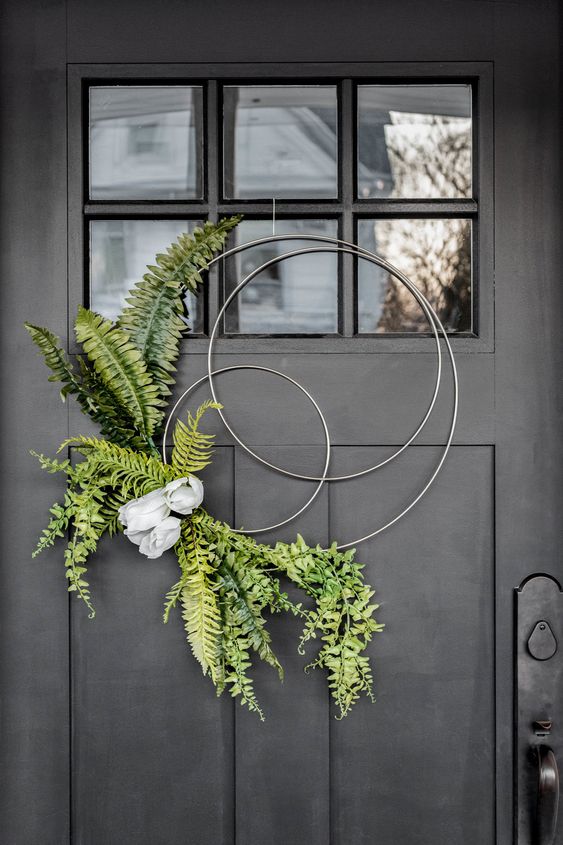 18 a modern and creative hoop spring wreath with ferns and some artificial blooms is very fresh and cool idea