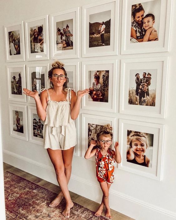 18 a modern gallery wall with white frames and colorful family pics looks more contemporary thanks to a grid form and matching frames
