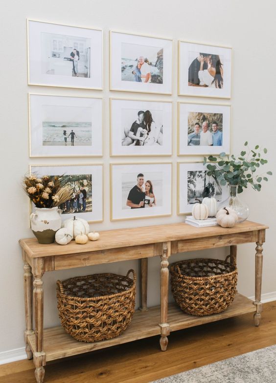 a modern grid gallery wall with matching gilded frames and colored family pics is a stylish idea to personalize your space