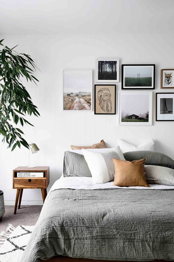 22 a contemporary gallery wall with a free form and mismatching frames plus prints and artworks that give it a modern feel