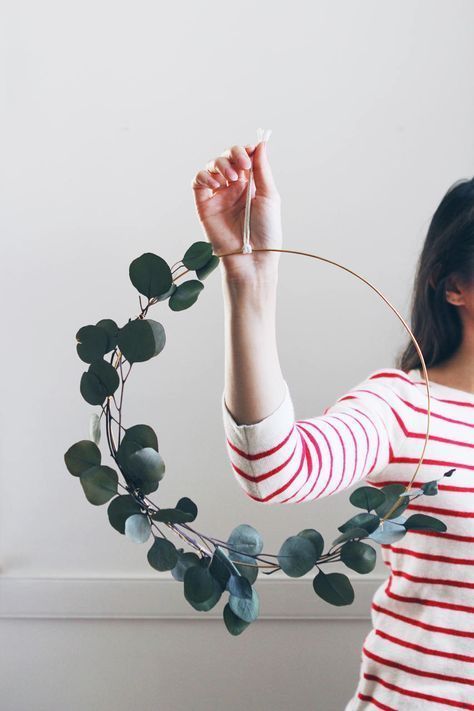 a modern spring wreath of a hoop and eucalyptus is a lovely and fresh idea in minimalist style