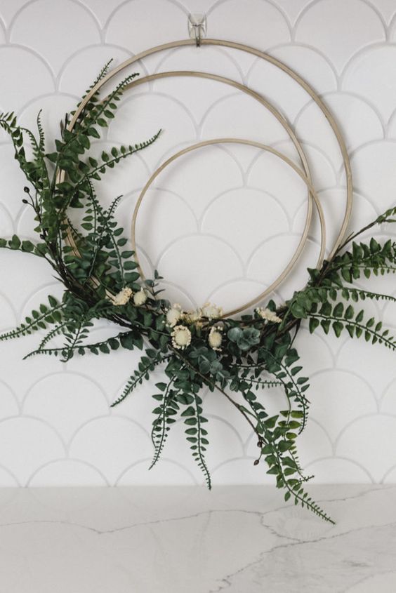 a modern wreath of several hoops, greenery and white blooms is a very fresh and new idea for spring