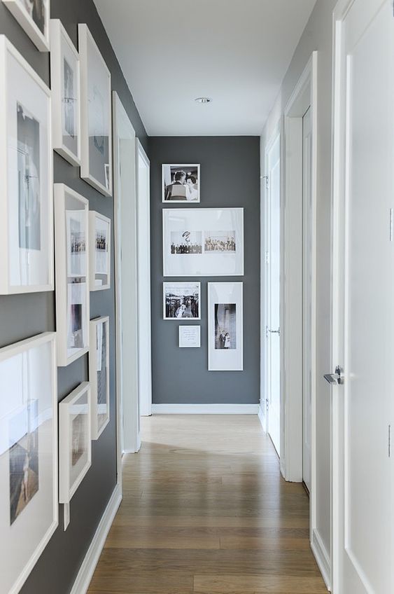 25 a laconic modern gallery wall with white frames and a free form is a cool way to style an awkward nook in a corridor