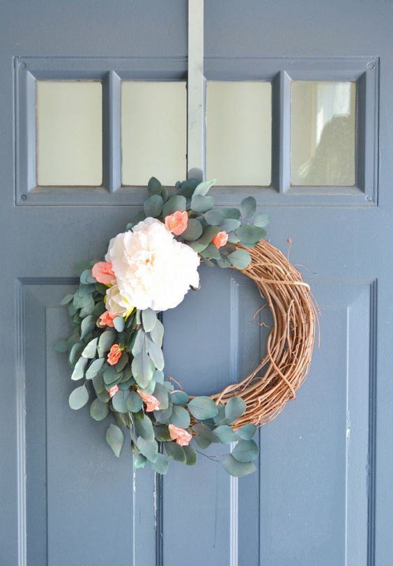 a simple and pretty rustic spring wreath of vine, eucalyptus, white and red blooms is a very lovely idea