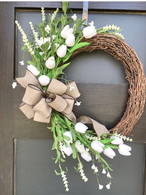 37 a simple rustic vine wreath with faux white tulips, greenery and a large urlap bow is a beautiful idea