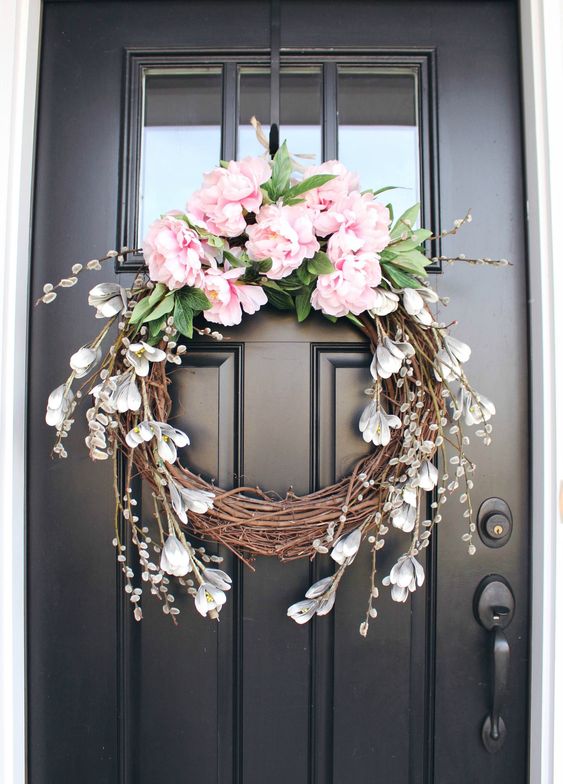 40 a vine wreath with pink peonies, faux greenery, some faux snowdrops is a pretty idea for a rustic space