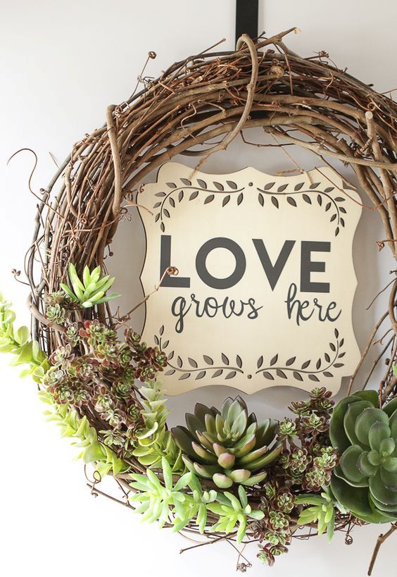 an awesome spring wreath of vine and succulents plus a plywood plaque is a cool and very modern idea