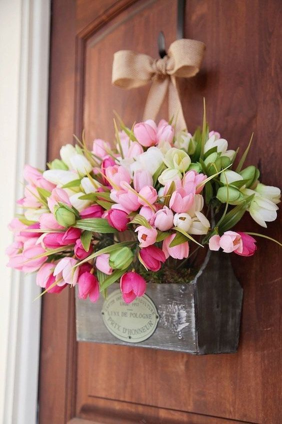 a substitute to a spring door wreath - a box with moss, pink and white tulips and a burlap bow looks creative and feels rustic