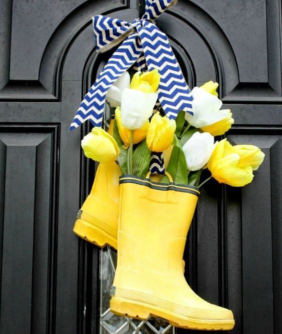 bright yellow rain boot decor with yellow and white tulips and a chevron bow is a very cool and bold idea