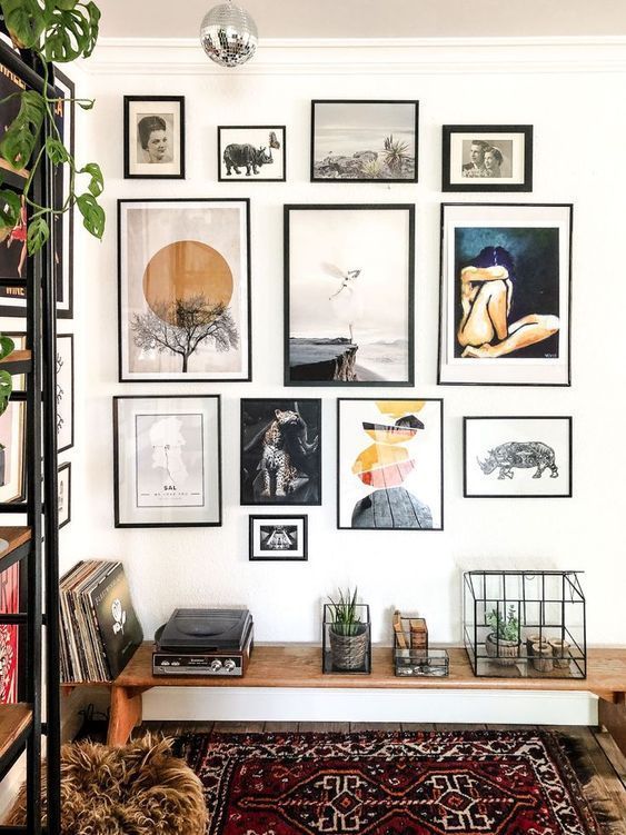 a beautiful gallery wall with various art, with mismatching black frames will add interest to your boho space