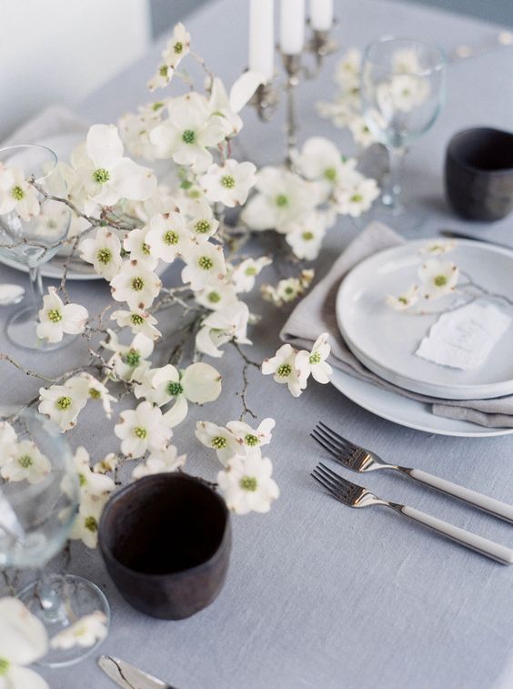 a beautiful white floral spring centerpiece right on the table is a fresh and romantic idea for a modern table