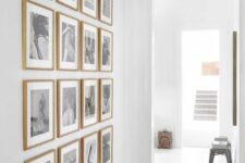a blank wall filled with a grid gallery wall with stained frames and black and white photos is pure elegance