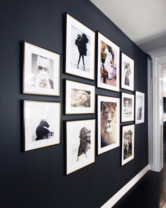 a bold and cool gallery wall with matching black frames and colored and black and white prints will add to the style