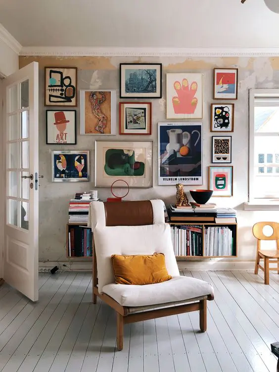A bold and jaw dropping gallery wall with lots of abstract art in mismatching frames gives a character to this neutral space