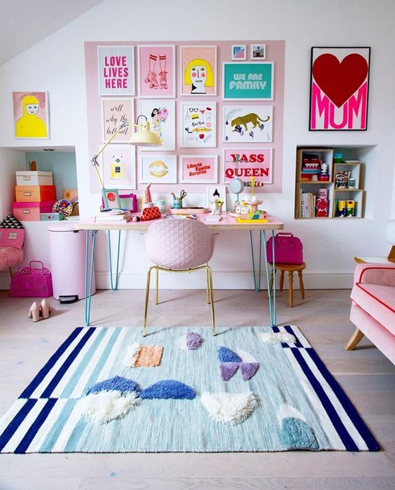 a bright and fun gallery wall on a pink part of wall, bright artworks, posters and signs is a gorgeous and glam idea