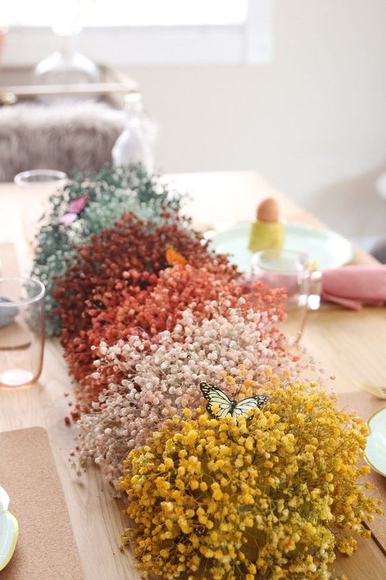 a bright baby's breath centerpeice with bold faux butterflies is a very fun and bold idea for spring and Easter