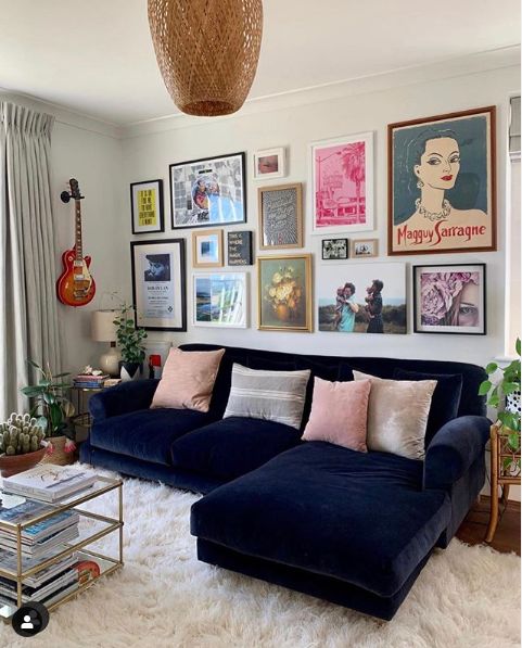 a bright gallery wall with mismatching frames and art of various types and sizes for an eclectic feel