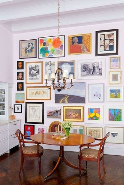 a cheerful and colorful free form gallery wall with mismatching frames and black and white and bold rainbow artworks is a fun idea