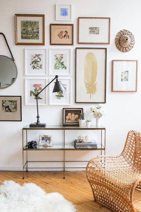 A chic gallery wall with thin frames and botanical theme as the main one feels very spring like