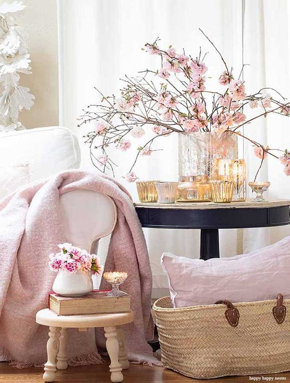 a chic vase with pink blooming branches and candles around is a beautiful idea for a spring tablescape or just your room