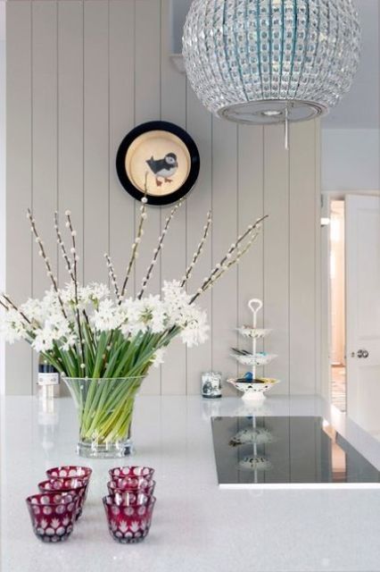 a clear vase with white blooms and willow is a lovely and fresh spring centerpiece to enjoy