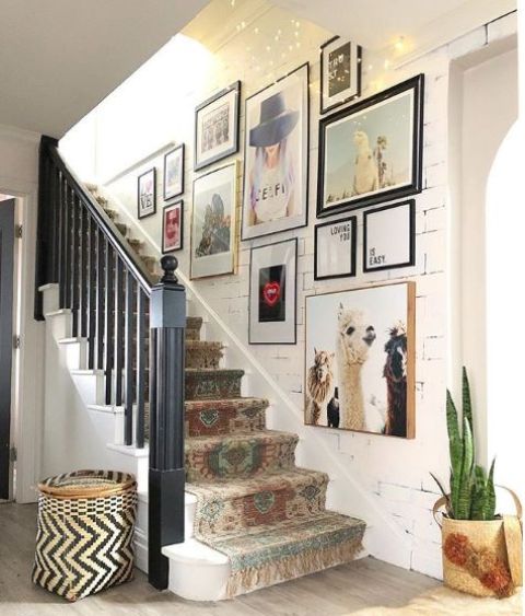 a colorful gallery wall with mismatching frames and colorful artworks is a stylish idea for a bold and fun eclectic space