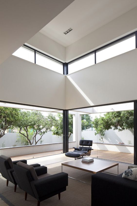 a contemporary black and white space with walls to remove and clerestory windows that bring more light to this double height ceiling space