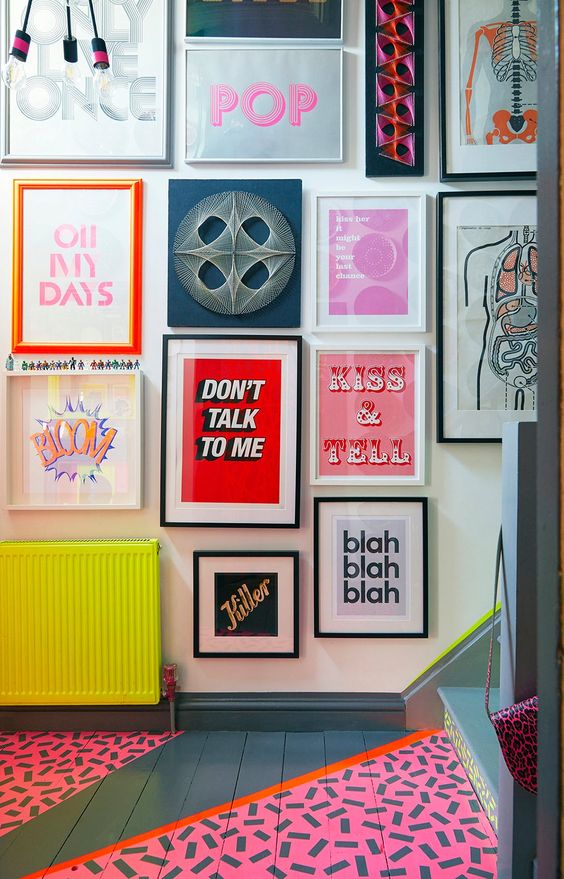 a crazy gallery wall with mismatching frames and all bold and fun art including posters and prints is a bold idea