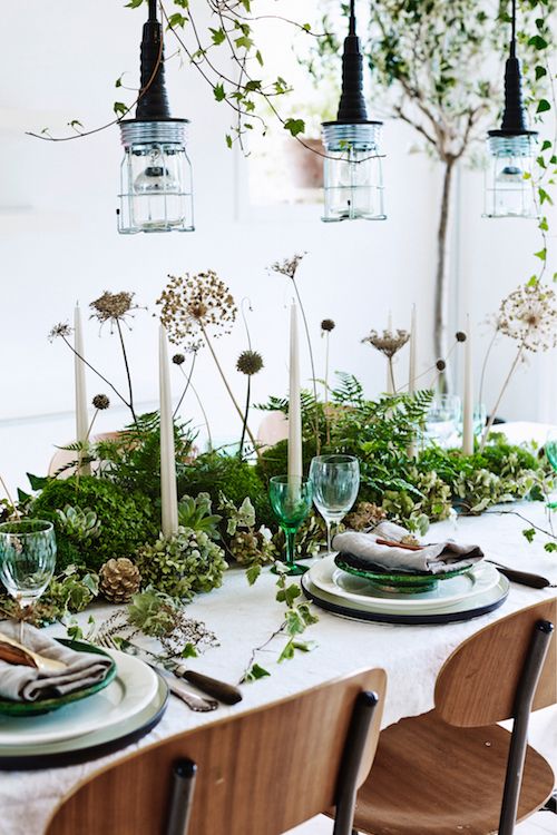 a fantastic woodland spring centerpiece of greenery, pinecones, dried flowers and grasses plus candles is fresh and cool