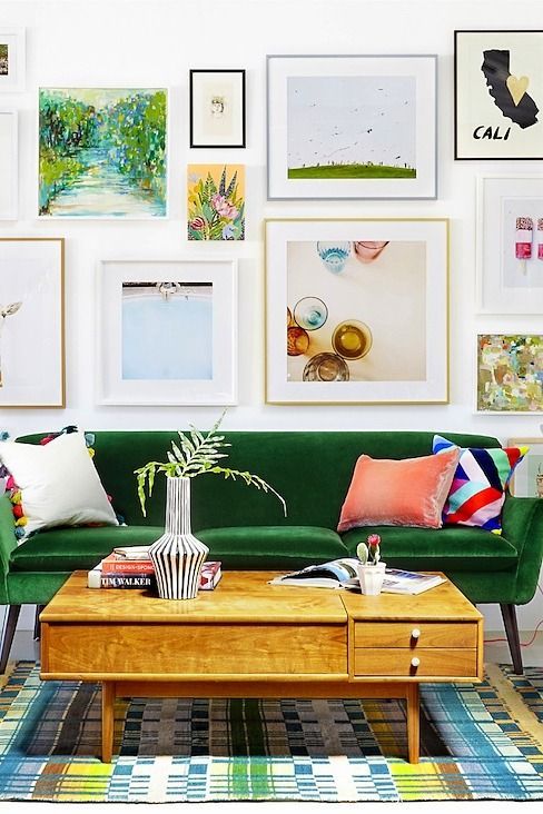 a gorgeous gallery wall in various colors, with mismatching frames and artworks and prints in bright shades