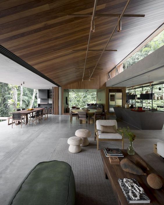 a large open space with a kitchen, dining room and a living room with a wall that cna be removed, a glass wall and clerestory windows