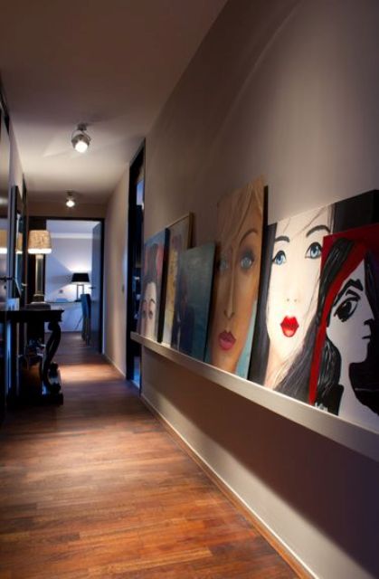 a long ledge with statement oversized artworks that make this corridor very special and very eye-catchy