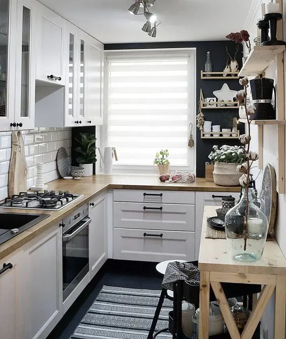 A lovely Scandinavian kitchen in black and white, with light stained wood and enough light is cool