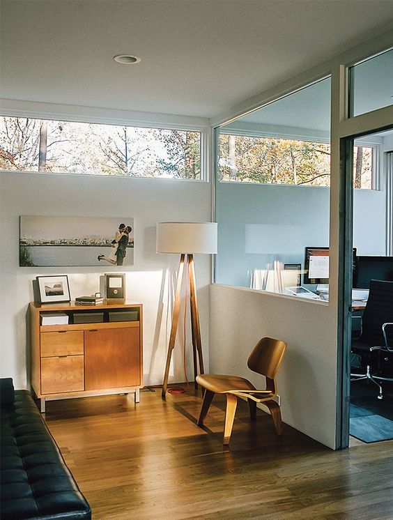 a mid-century modern space - a bedroom and a home office, with clerestory windows for more light and views