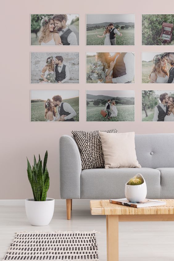 a modern gallery wall with super thin white frames, no matting and colorful family pics is a fresh idea